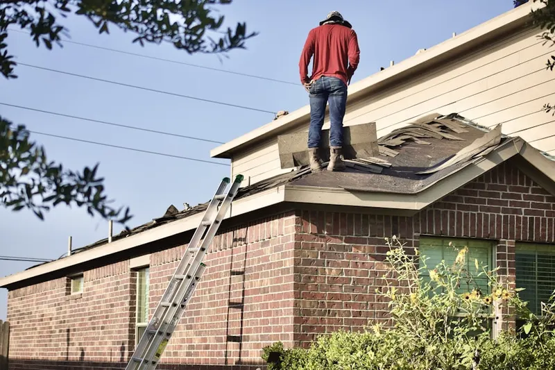 Professional roofer working on a residential roof in Amelia